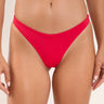 a woman wearing a red bikini bottom on a neutral background