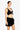 Woman wearing a black bikini top and sarong on a white background