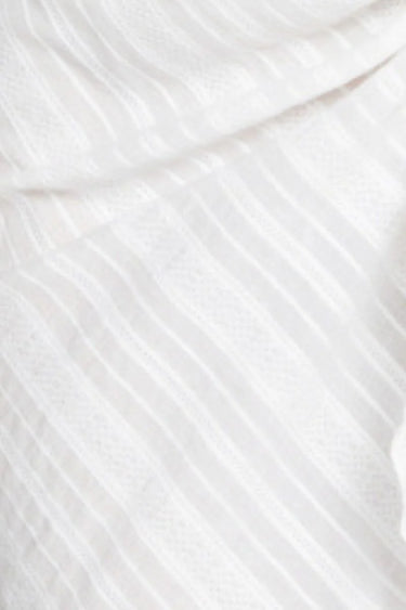 Close-up of white fabric with a subtle pattern