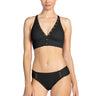 Woman wearing a black bikini with gold accents on a white background