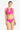Woman wearing a pink bikini with gold buttons on a white background