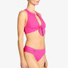 Woman wearing a pink bikini set on a white background