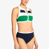 a woman wearing a color block tank bikini top and navy bottoms on a white background