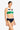 a woman wearing a color block tank bikini top and navy bottoms on a white background