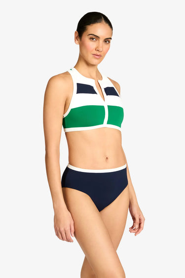 a woman wearing a color block tank bikini top and navy bottoms on a white background
