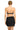 Woman wearing a black strapless top and skirt on a white background