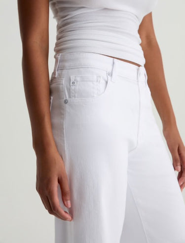 A close up side view of the white denim jeans on a white background 