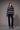 Black and white Fair Isle patterned sweater styled with slim black pants and black heels on a model.