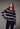 Black and white Fair Isle patterned sweater styled with slim black pants and black heels on a model.