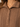 Close-up of a brown cable-knit polo shirt with a collar and three buttons, worn by a model.