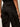 Close-up back view of a person wearing black wide-leg trousers with a satin-like finish, showing the back pockets and waistband.