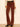 A person wearing brown corduroy flared pants with a black belt, paired with a cream lace long-sleeve top and black pointed-toe heels, standing against a plain light beige wall.