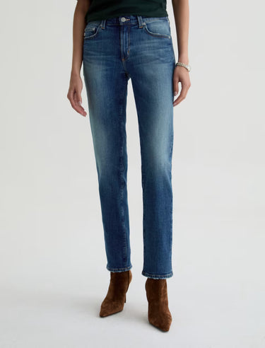Person wearing blue jeans on a white background