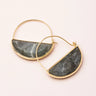 Gold hoop earrings with semi-circular stone inlays on a light background