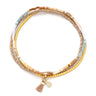 Multicolored beaded bracelet with tassel charm on a white background