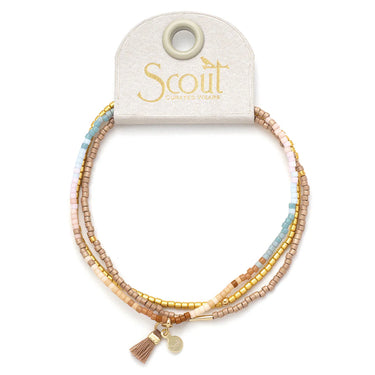 Set of beaded bracelets with a Scout branded card on a white background