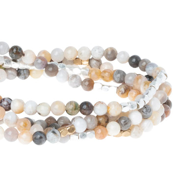Set of multicolored beaded bracelets on a white background