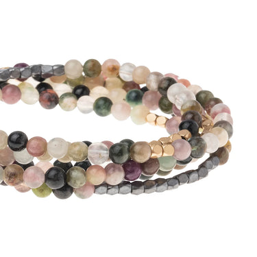 Set of multicolored beaded bracelets on a white background