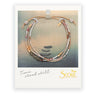 Beaded necklace on a Scout branded card with a scenic background