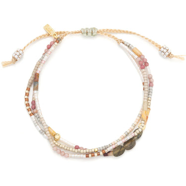Multistrand beaded bracelet with gold accents on a white background
