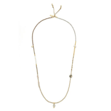 Necklace with small beads and a central pendant on a white background
