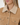 Close-up of a woman wearing a tan suede jacket with a thick cream sherpa fleece collar and matching trim.