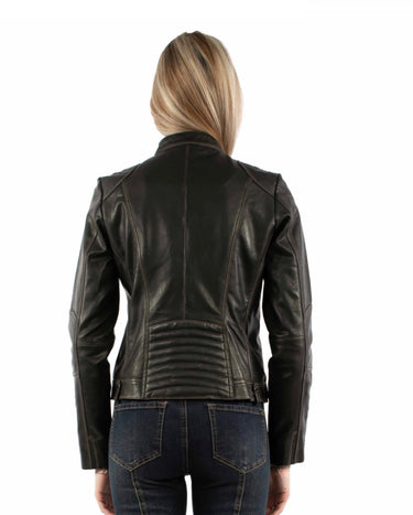a woman wearing a black leather jacket with a vintage feel and zipper detailing with blue jeans on a white background