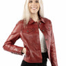 A woman wearing a soft red leather jacket and black pants on a white background