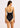 Woman wearing a black and white swimsuit on a neutral background