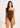 Woman wearing a brown swimsuit with white trim on a light pink background