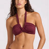 The front view of a wrap halter burgundy swim top on a model on a white background
