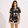 a Hawaiian black button up shirt on a model on a neutral background