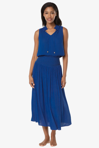 Woman wearing a blue sleeveless top and skirt set on a white background