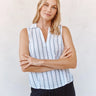Woman wearing a sleeveless striped shirt against a plain background