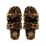 Pair of leopard print slippers with black bows on a white background
