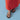 Brown sandals worn with a red skirt on a light blue background