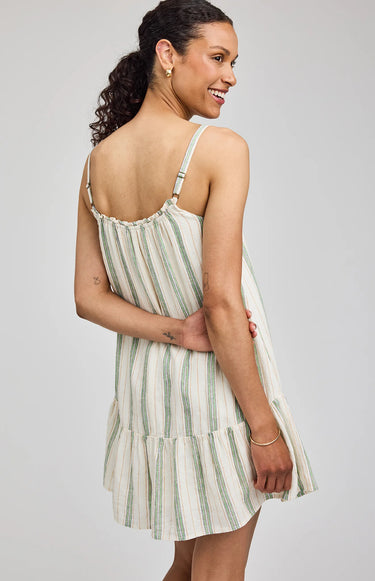 Woman wearing a striped dress on a plain background