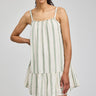 Woman wearing a striped dress on a plain background