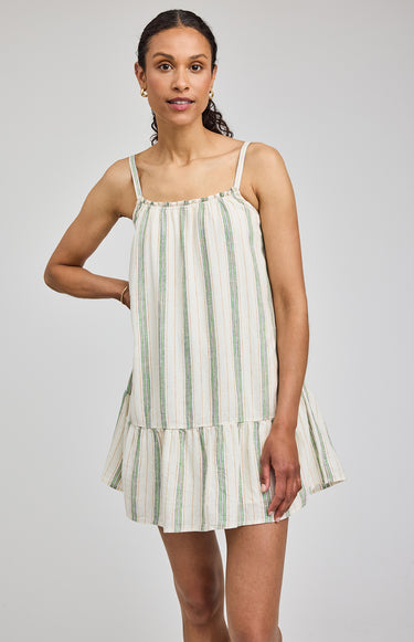 Woman wearing a striped dress on a plain background