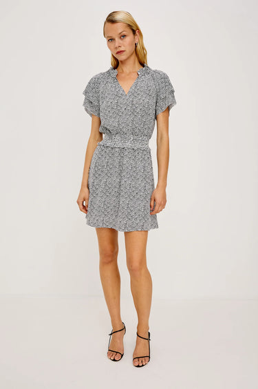 Woman wearing a patterned dress on a white background