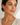 A woman wearing 4 stone drop earrings