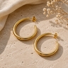 A pair of half hoop 45mm hoop earrings with a stud back