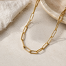 A gold chain necklace on a textured table