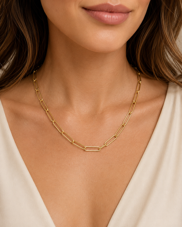 a woman wearing a gold chain necklace