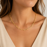 a woman wearing a hammered paper clip gold-plated necklace.