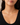 A close-up of a model wearing a delicate gold chain necklace with a small central pearl, styled with a black scoop-neck top.