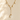 A delicate gold Y-necklace featuring small pearl-like beads and a large teardrop-shaped clear stone pendant, displayed on a warm beige background with soft leaf shadows.