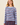 A woman wearing a light blue ribbed knit sweater with horizontal navy and red stripes, paired with a matching striped skirt, against a solid beige background.