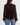 A textured black dot sheer chocolate blouse with blousy sleeves and blue jeans.
