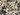 A close-up of a textured fabric with a floral pattern in navy blue and olive green on a warm cream background.